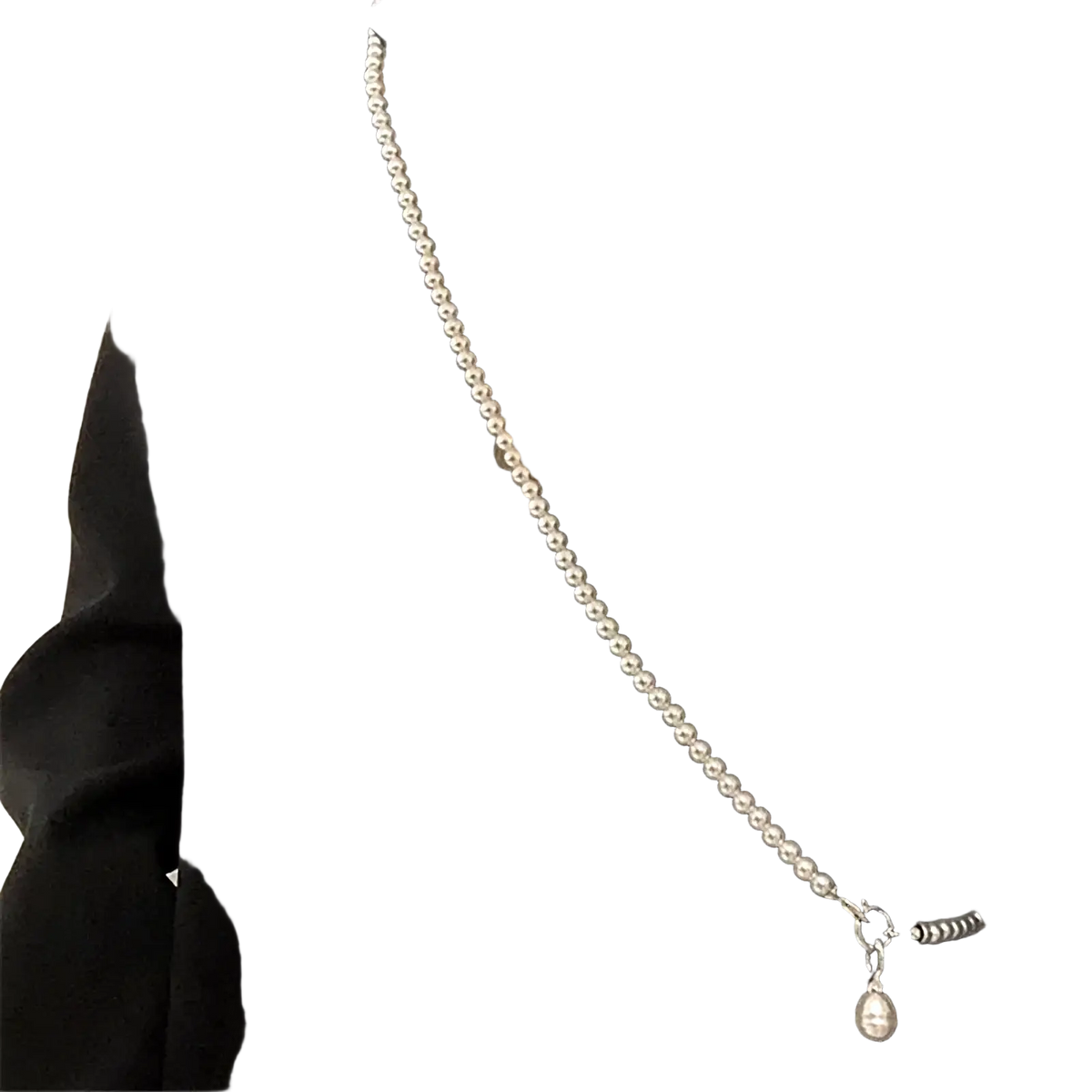 A delicate silver-toned pearl crossbody pendant necklace for women with a teardrop-shaped pendant