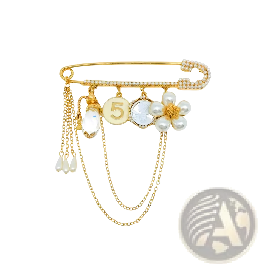 Gold-toned safety pin brooch with dangling chains, pearl flower, crystal pendant, and engraved number five charm
