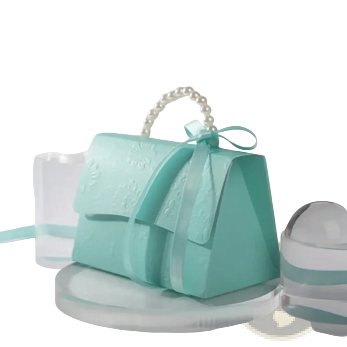 A delicate mint green paper handbag with a pearl handle and satin bow for party favor gift box candy packaging