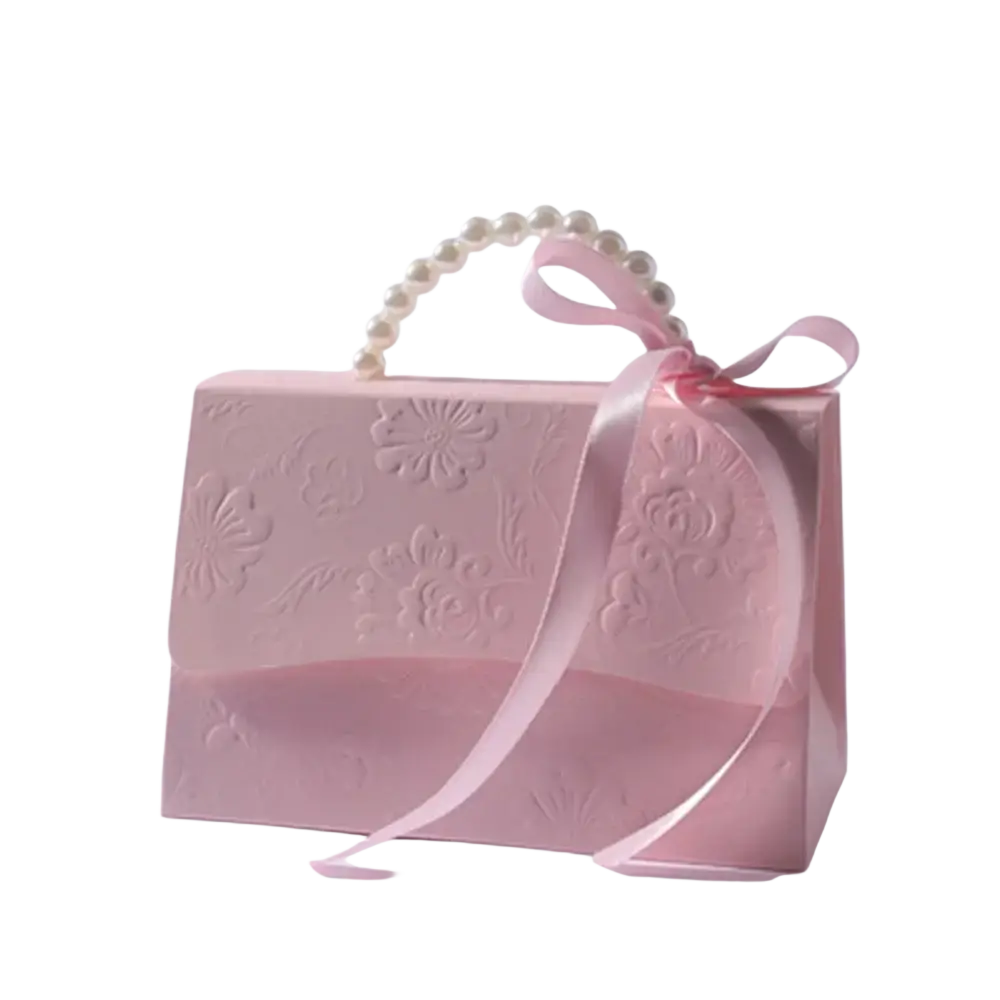 A delicate pink gift box with embossed floral pattern pearl-handled strap and satin ribbon bow for party favors