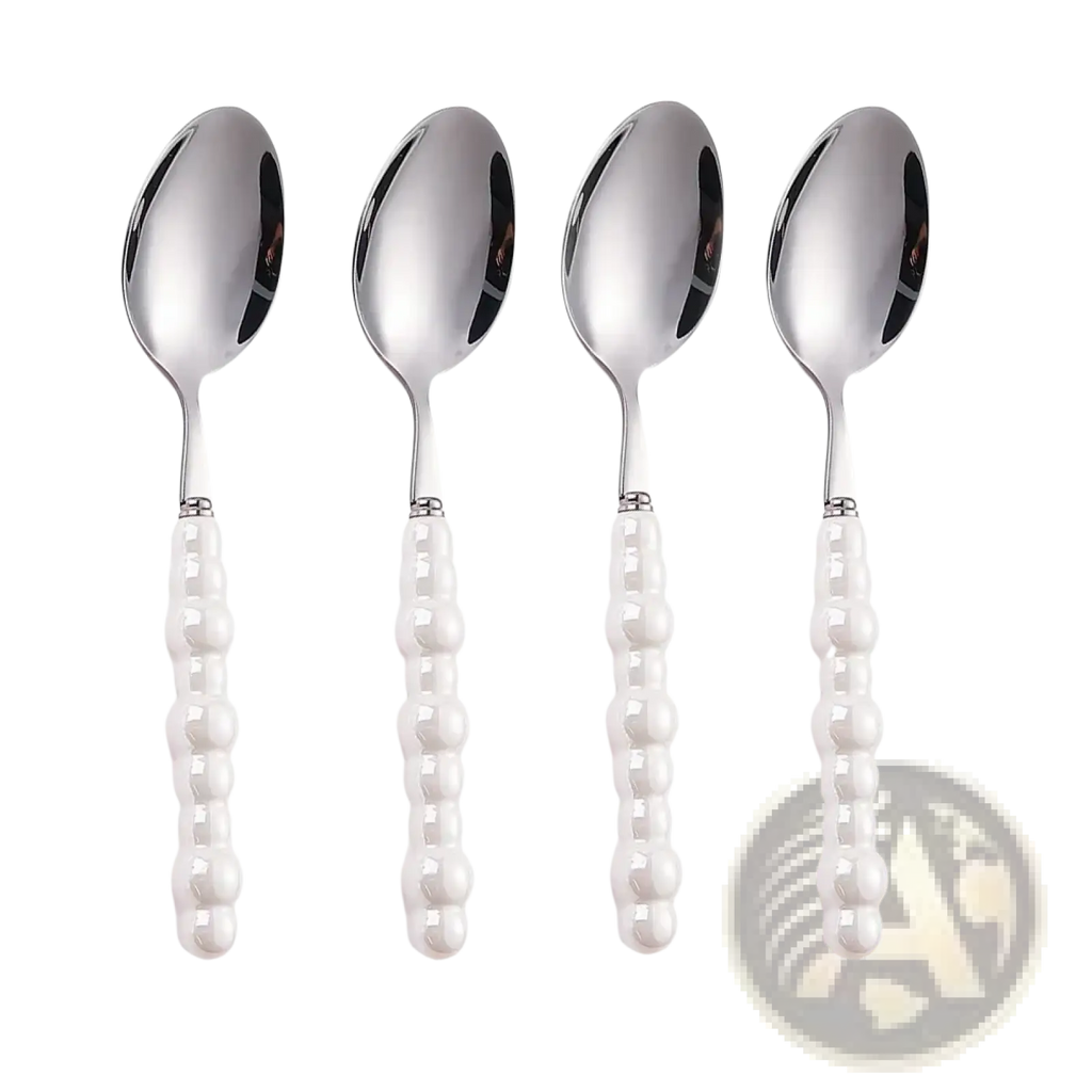 Set of four elegant silver stainless steel spoons with pearl like white beaded handles for dining use