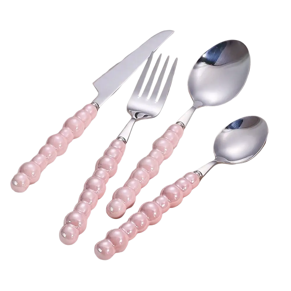 Set of four stainless steel cutlery pieces with pink beaded pearl handles for elegant dining
