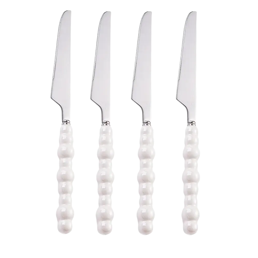 Set of four white ceramic handled butter knives with silver stainless steel blades from pearl handle cutlery set