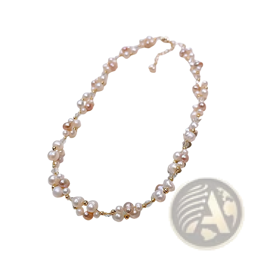 A delicate necklace with mixed pink and white freshwater pearls and gold beads on a 14k gold filled chain