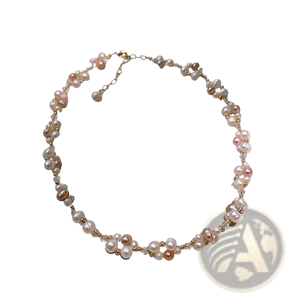 A delicate pearl jewelry set with mixed pink and white freshwater pearls on a 14k gold filled chain