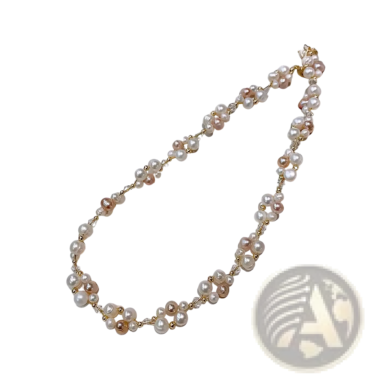 A delicate pearl necklace with white and pink freshwater pearls and gold beads on a 14k gold filled chain