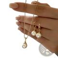 A delicate rose gold pearl jewelry set featuring a freshwater pearl necklace and matching hoop earrings