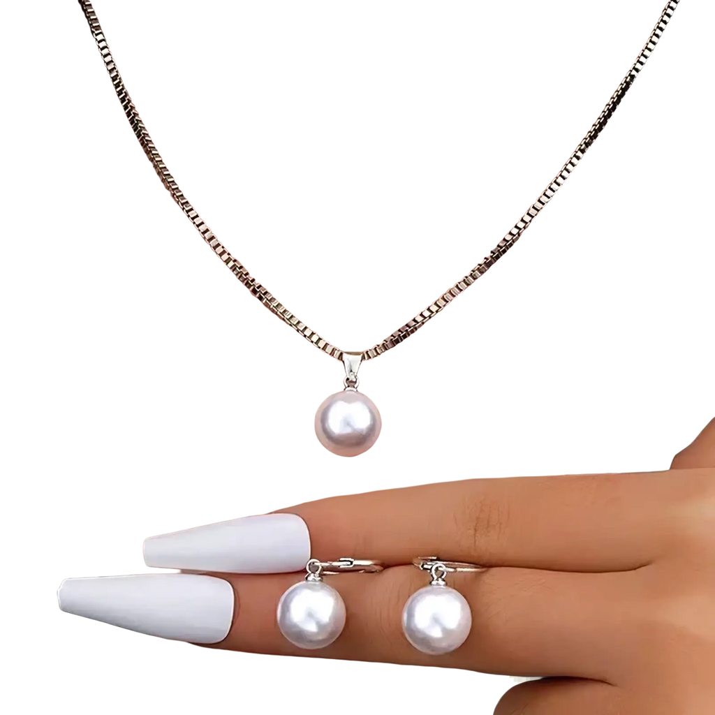 A delicate silver chain necklace with a single white pearl pendant and matching pearl stud earrings set