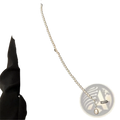 A delicate silver-toned pearl pendant long necklace with a teardrop-shaped pendant designed as an elegant crossbody strap accessory