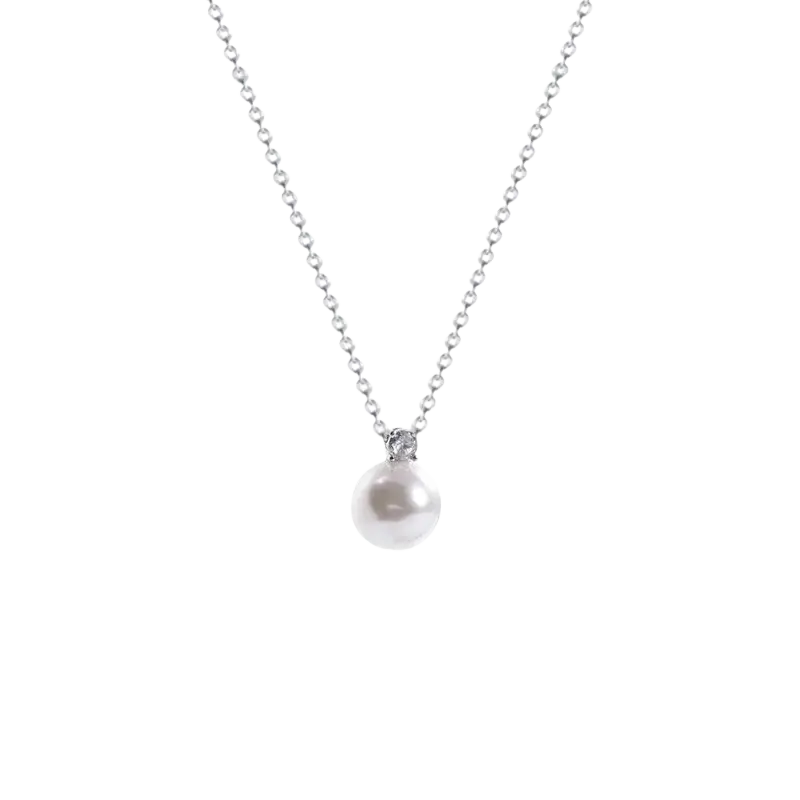 A silver clavicle chain necklace with a white pearl pendant and a small diamond accent at the top