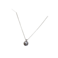 A silver clavicle chain necklace with a single gray pearl pendant and a small diamond accent at the top