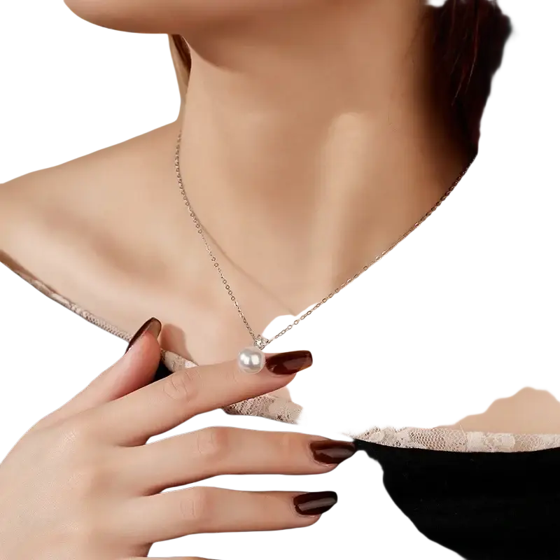 A delicate silver chain necklace featuring a single lustrous white pearl pendant with diamond accents