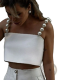 White satin crop top with pearl-embellished straps showcasing elegant detail and luxurious fabric texture
