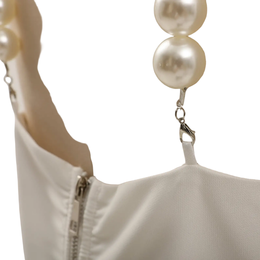 Pearl strap satin crop top white featuring a delicate pearl necklace with large white beads and silver clasp on strap