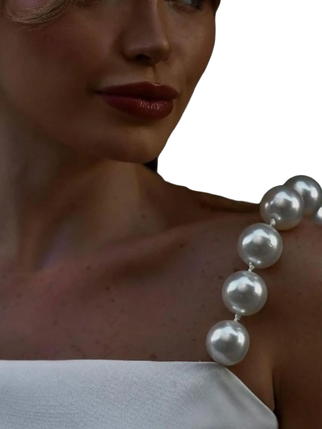 Pearl strap satin crop top white featuring a lustrous string of spherical white pearls draped elegantly across the shoulder