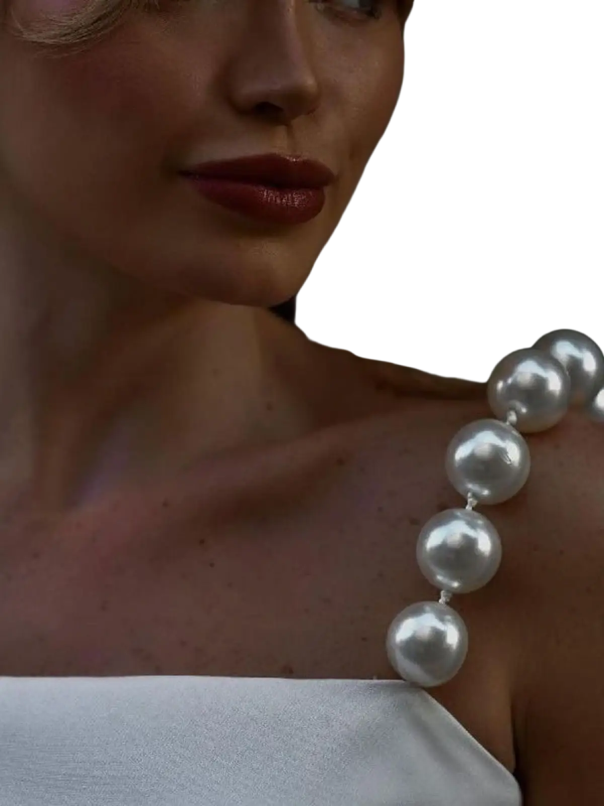 Pearl strap satin crop top white featuring a lustrous string of spherical white pearls draped elegantly across the shoulder