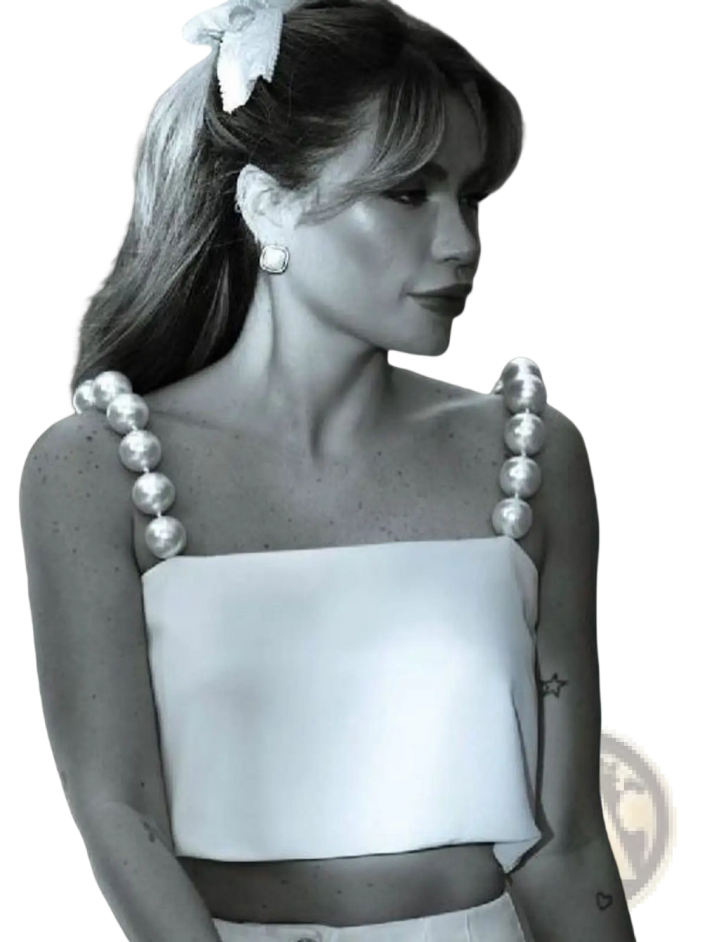 A woman wears a white satin crop top with thick pearl-adorned shoulder straps in a pearl strap satin crop top white