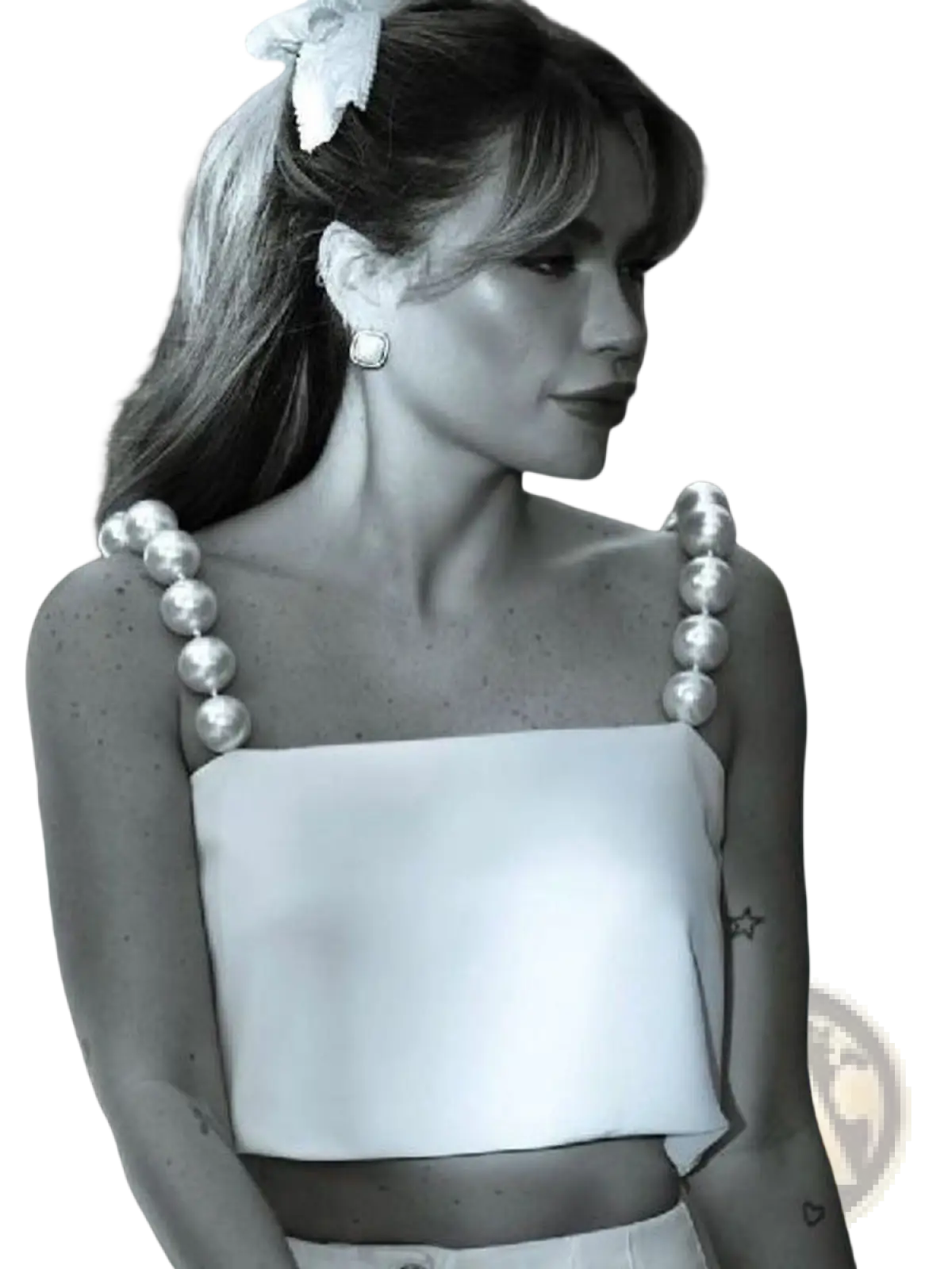 A woman wears a white satin crop top with thick pearl-adorned shoulder straps in a pearl strap satin crop top white