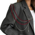 Pearl tassel chain brooch with silver chain, red beads, and airplane charm pinned on a pinstripe blazer shoulder