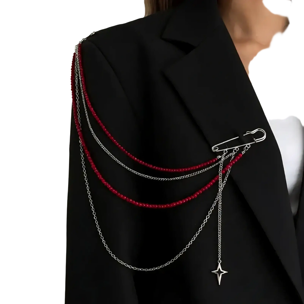 Silver safety pin brooch with layered chains, red beads, and a star pendant in an elegant vintage pearl tassel design