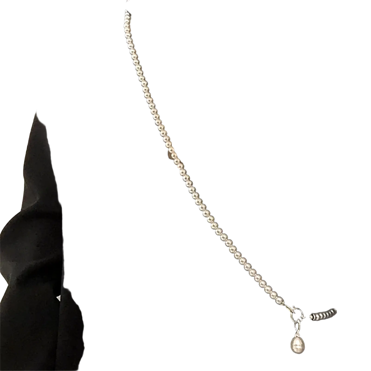 A delicate silver-toned pearl teardrop pendant necklace featuring a single dangling pearl pendant