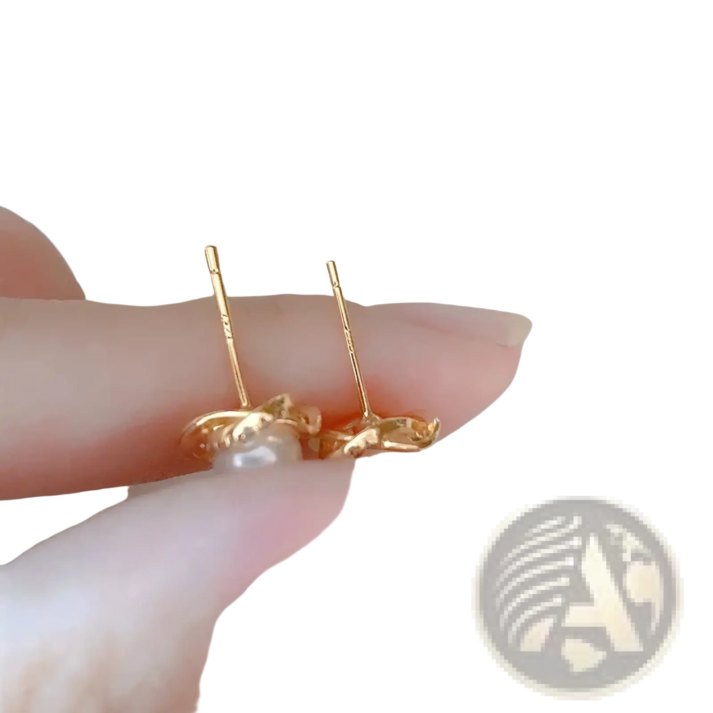 Pearl twist gold stud earrings featuring a delicate twisted gold design with a single pearl center