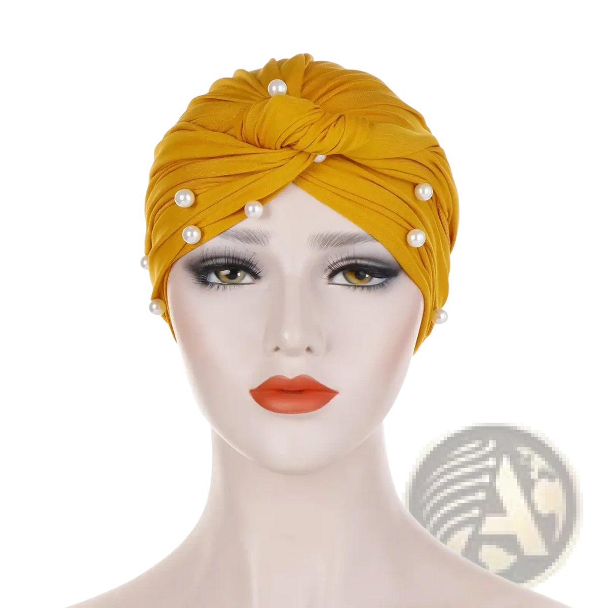 A golden-yellow velvet turban hijab for women adorned with evenly spaced white pearls along its twisted design