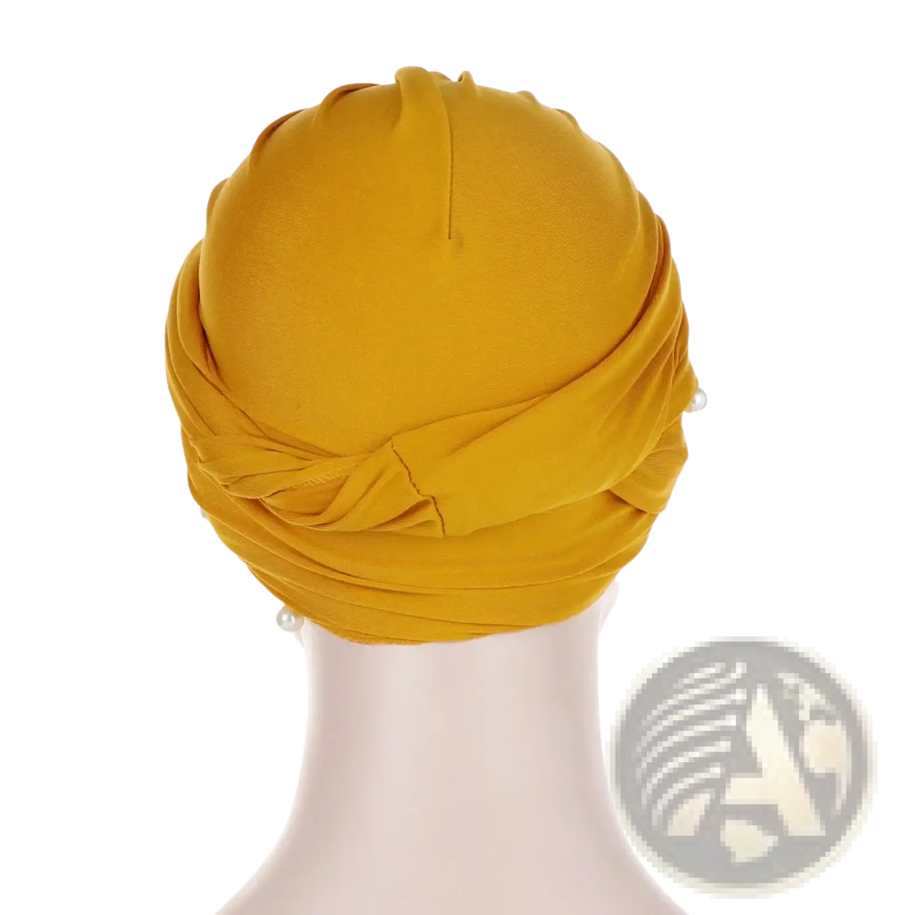A vibrant mustard-yellow pearl velvet turban hijab for women with soft draped fabric and subtle pearl accents