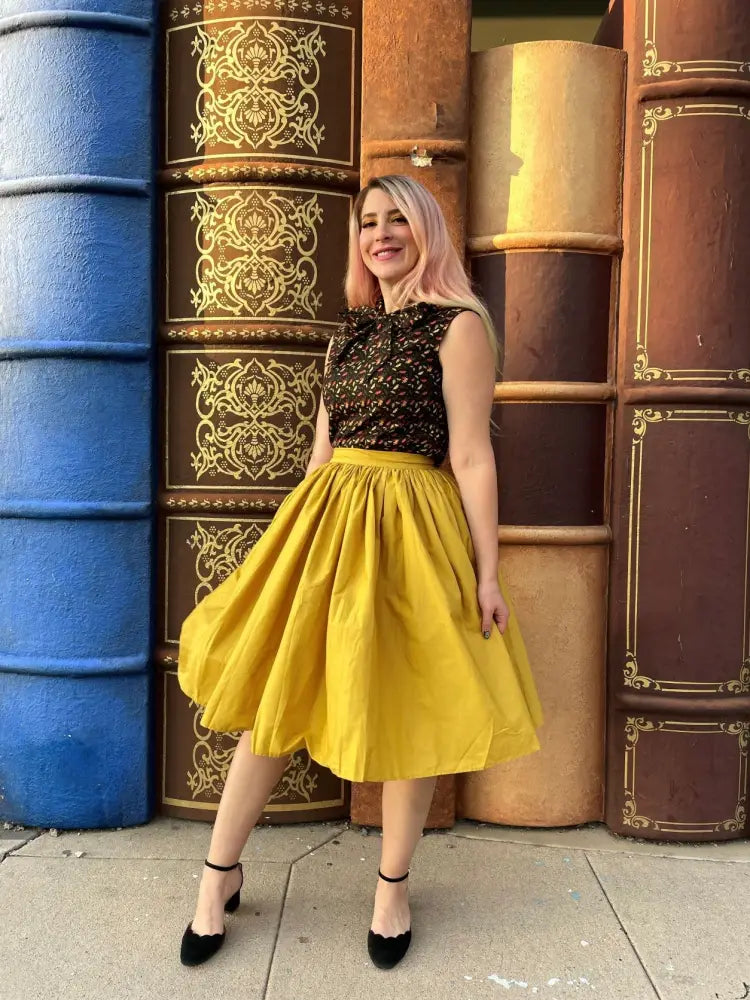 A vibrant yellow cotton swing skirt midi dress with a black lace bodice featuring pockets by Peggy Mustard
