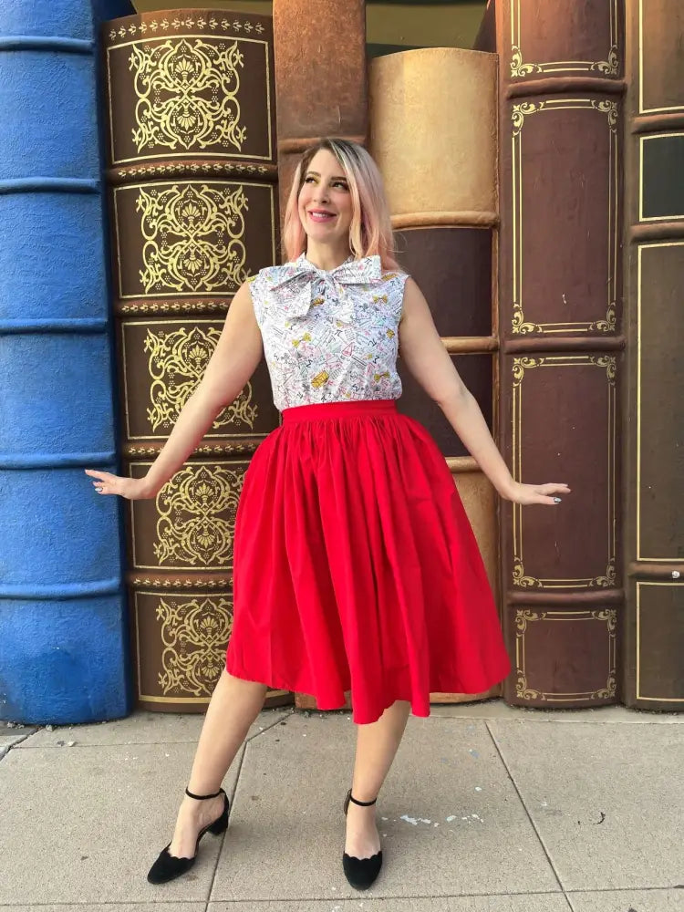 A vibrant red cotton midi swing skirt with a fitted waistband and pockets designed for comfortable wear