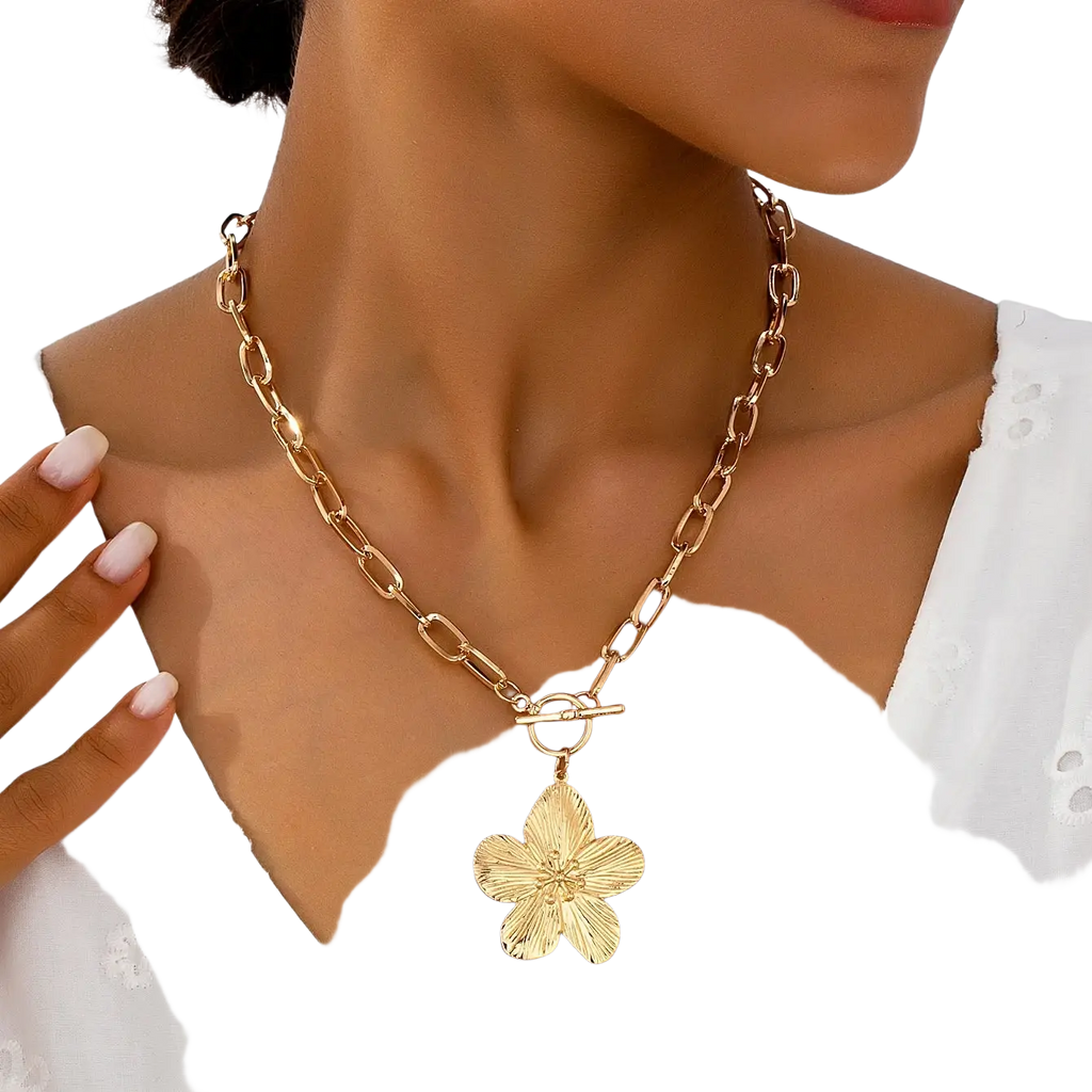 Gold-toned pendant necklace featuring a textured five-petal wisteria flower pendant with a toggle clasp