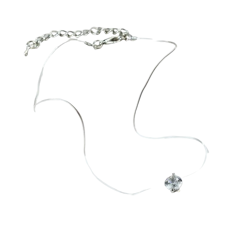 A delicate silver pendant necklace with a simple round single clear faceted crystal rhinestone pendant