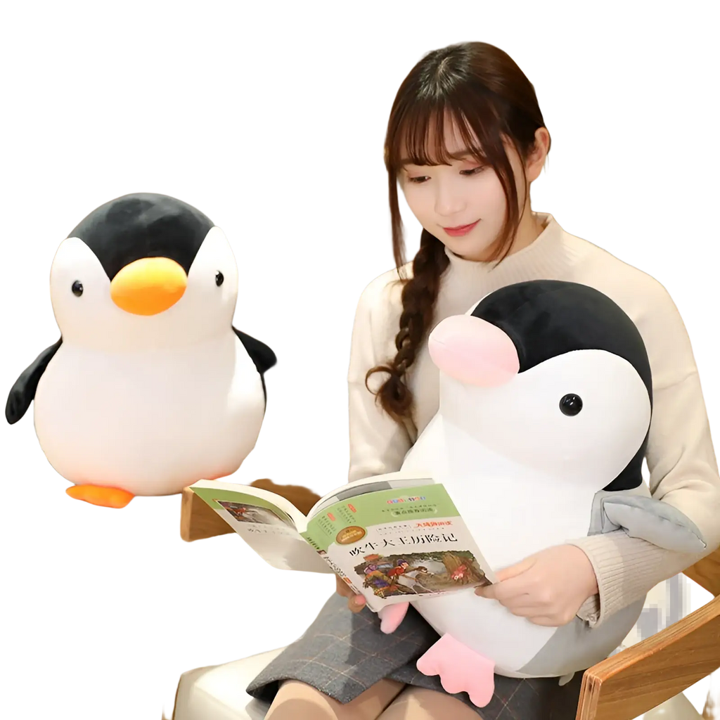 Soft white and black plush penguin toy with orange beak and feet and pink inner wing details for kids and teens