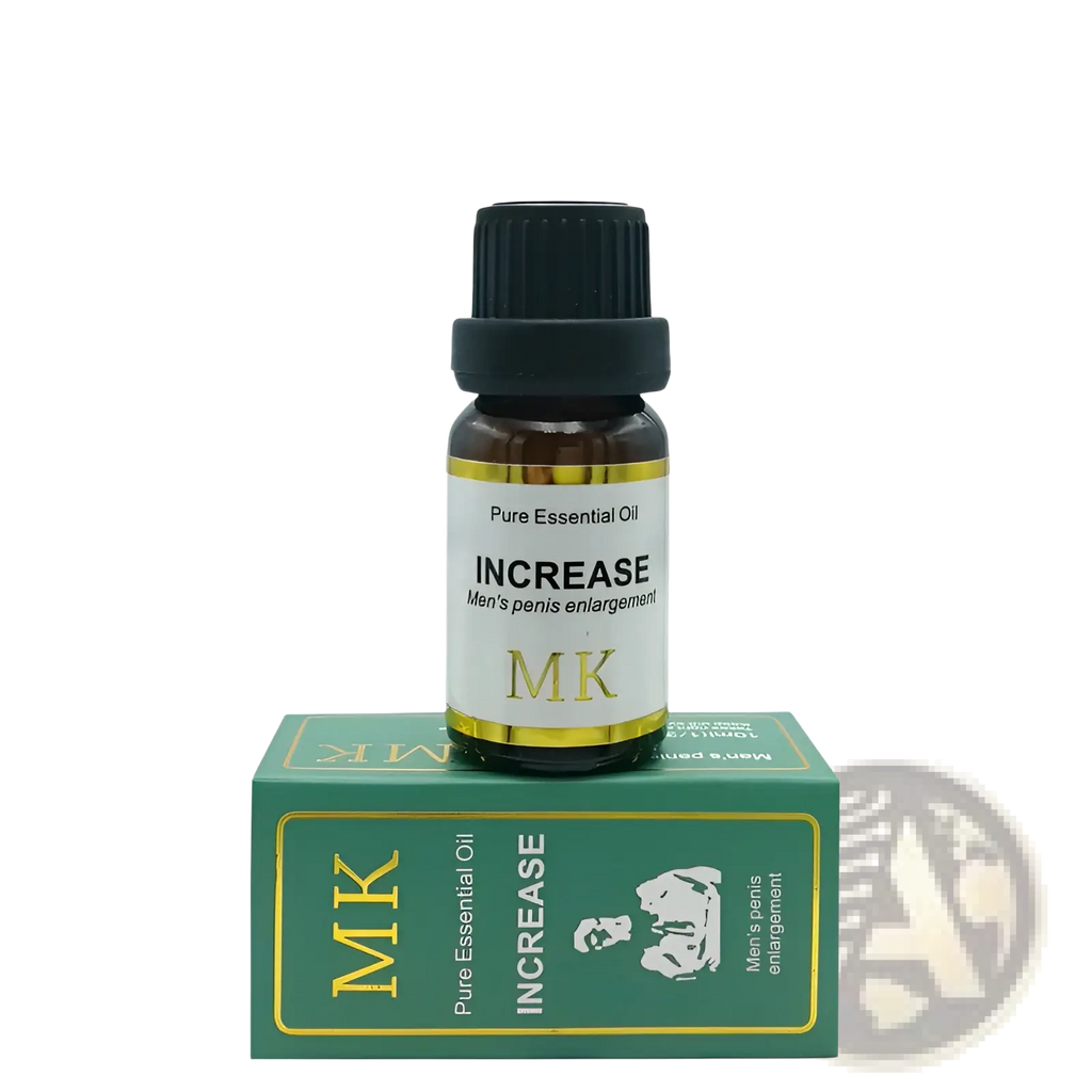 A small amber glass bottle with black ribbed cap and gold trimmed white label of penis enlargement essential oil mk atop green box