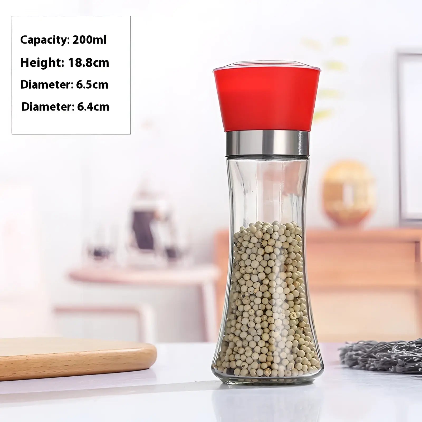 A clear glass pepper grinder with a red plastic top and silver metal band filled with white peppercorns in a 4 pack