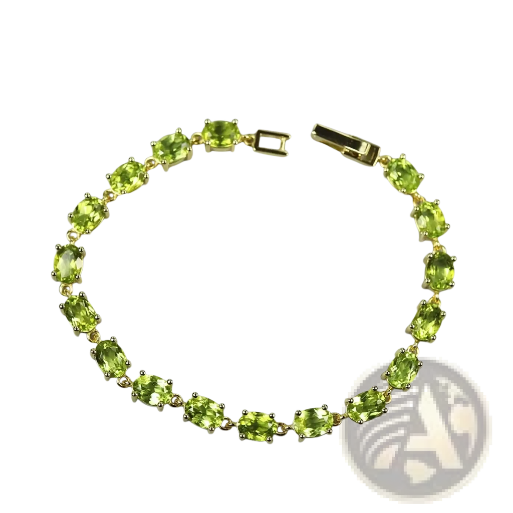 A delicate gold toned peridot sterling silver tennis bracelet with oval cut stones in a classic link design