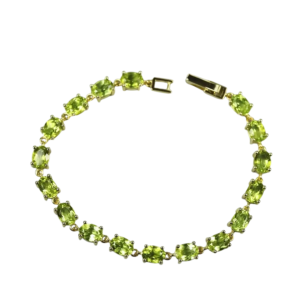 A delicate gold toned peridot sterling silver tennis bracelet with oval cut stones in a classic link design