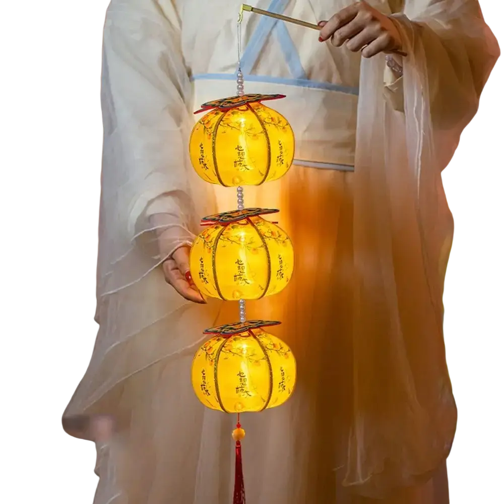 A persimmon lantern led decor glowing yellow with intricate black calligraphy and floral designs in a tiered arrangement