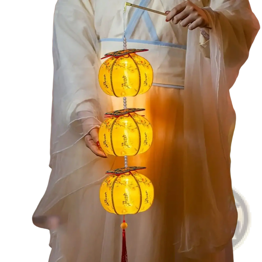 A persimmon lantern led decor glowing yellow with intricate black calligraphy and floral designs in a tiered arrangement