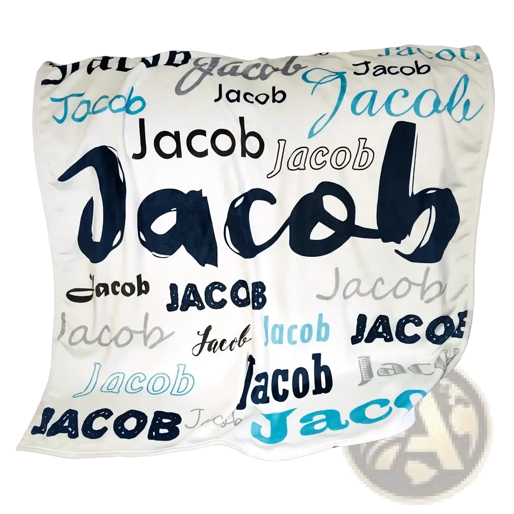 Personalized baby swaddle blanket fleece in soft white with the name jacob in navy blue teal and black fonts