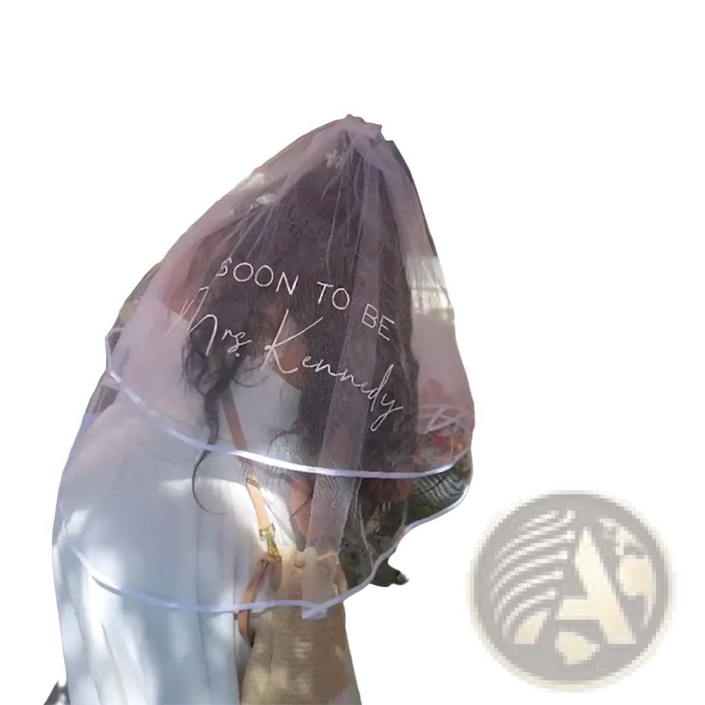 A delicate translucent pink personalized bachelorette party veil with soon to be mrs for bridal shower use