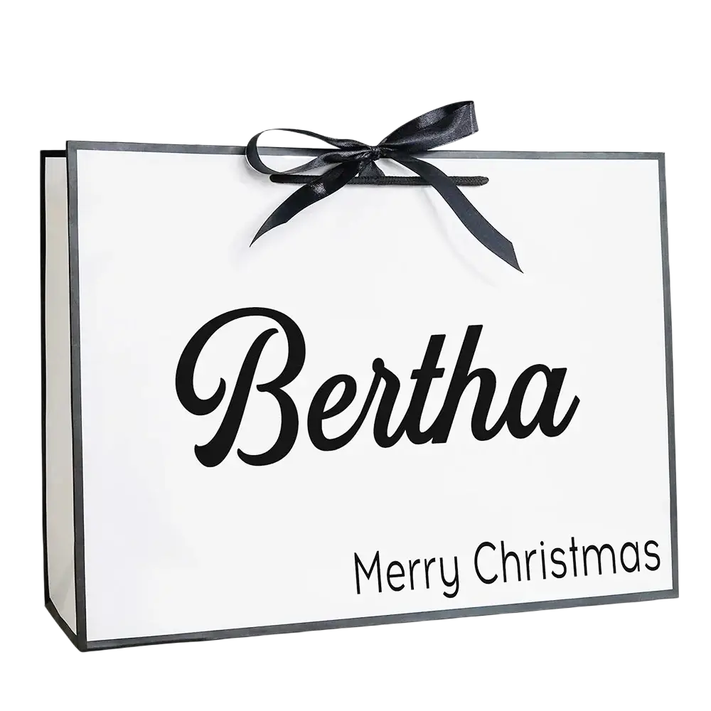 White personalized bridesmaid gift bag with black cursive name and merry christmas tied with glossy black ribbon