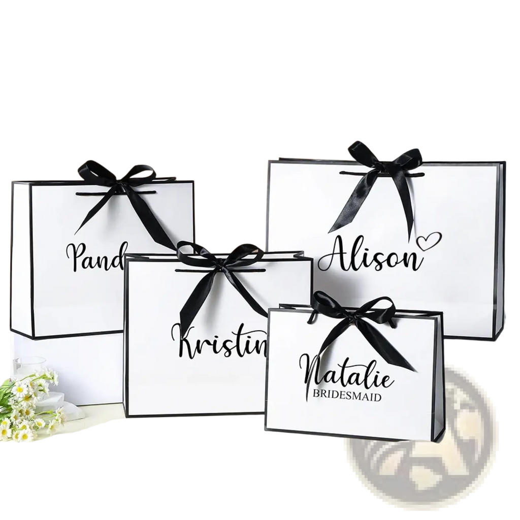 Personalized bridesmaid gift bags white paper with black ribbons and custom elegant cursive names for weddings