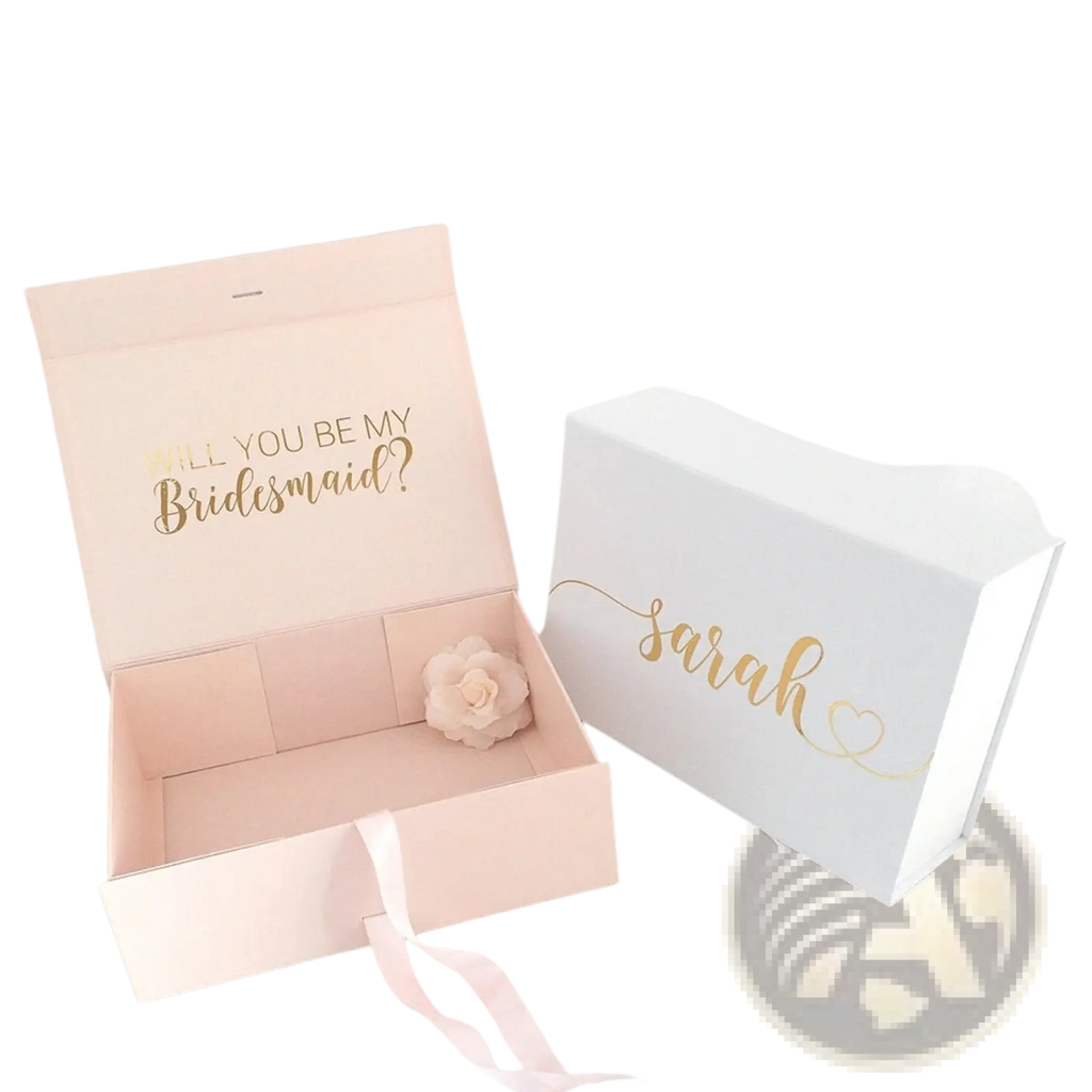 Personalized pink bridesmaid proposal gift box with gold foil lettering and white flower next to white box named sarah