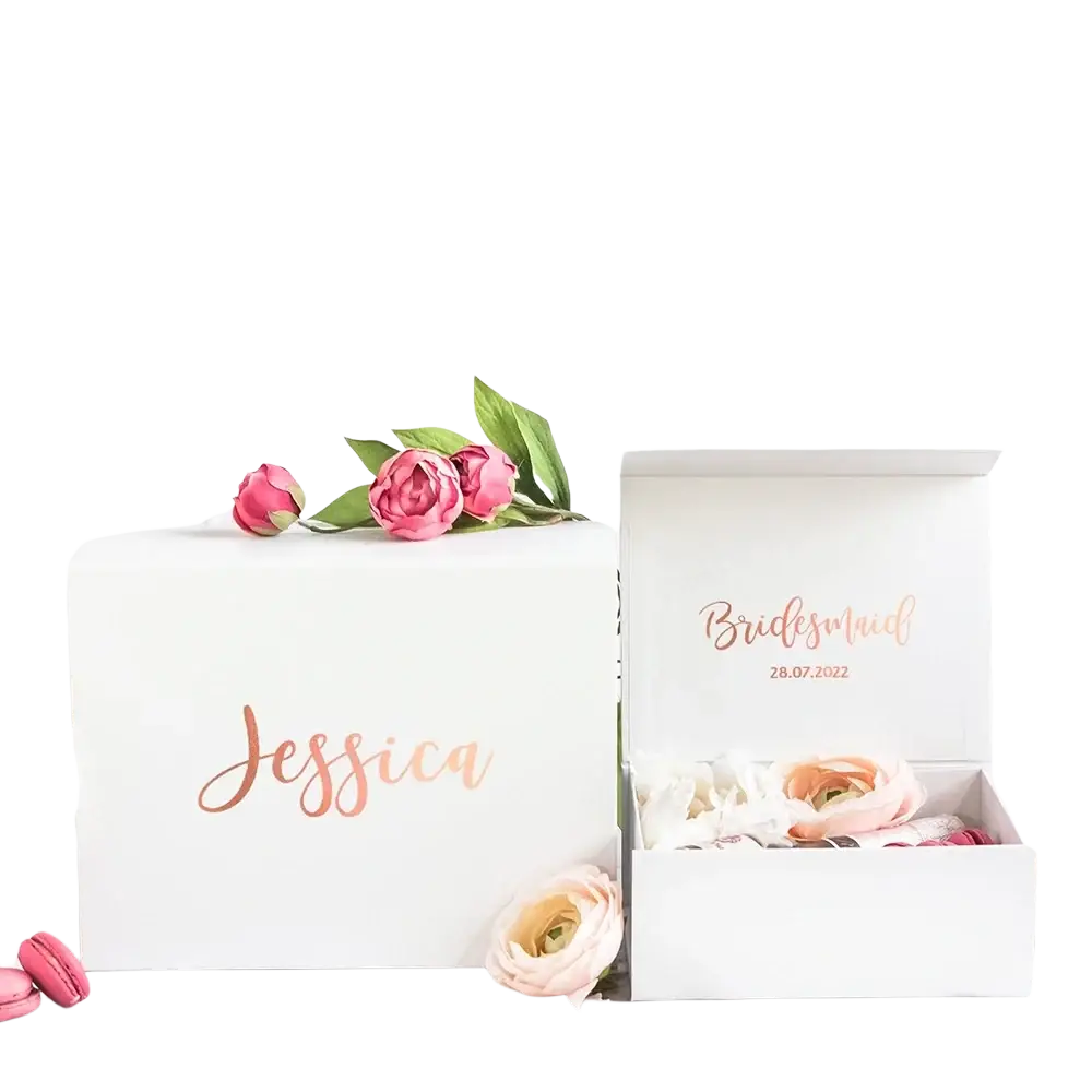Personalized white bridesmaid proposal gift box with ribbon featuring rose gold cursive lettering and floral accents