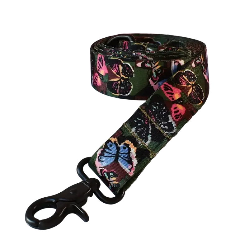 A vibrant green fabric leash with colorful butterfly patterns and black metal clasp fits neck size comfortably