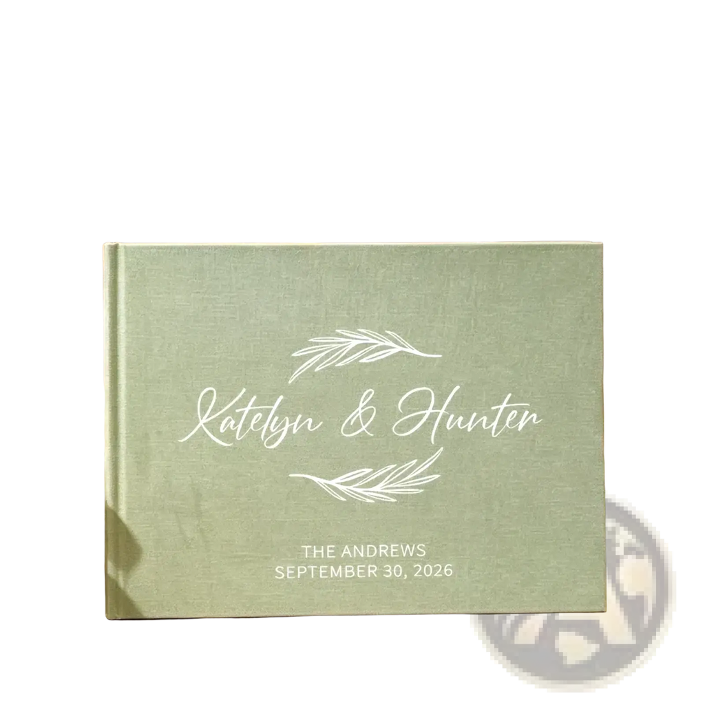 Personalized green linen wedding guest book with mint green linen texture white engraved names and leaf designs