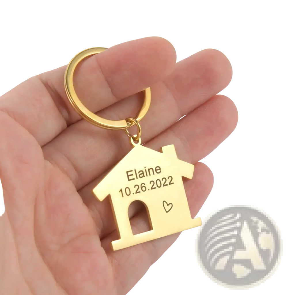 Gold-colored house-shaped keychain made of metal with engraved name and date personalized couple gift