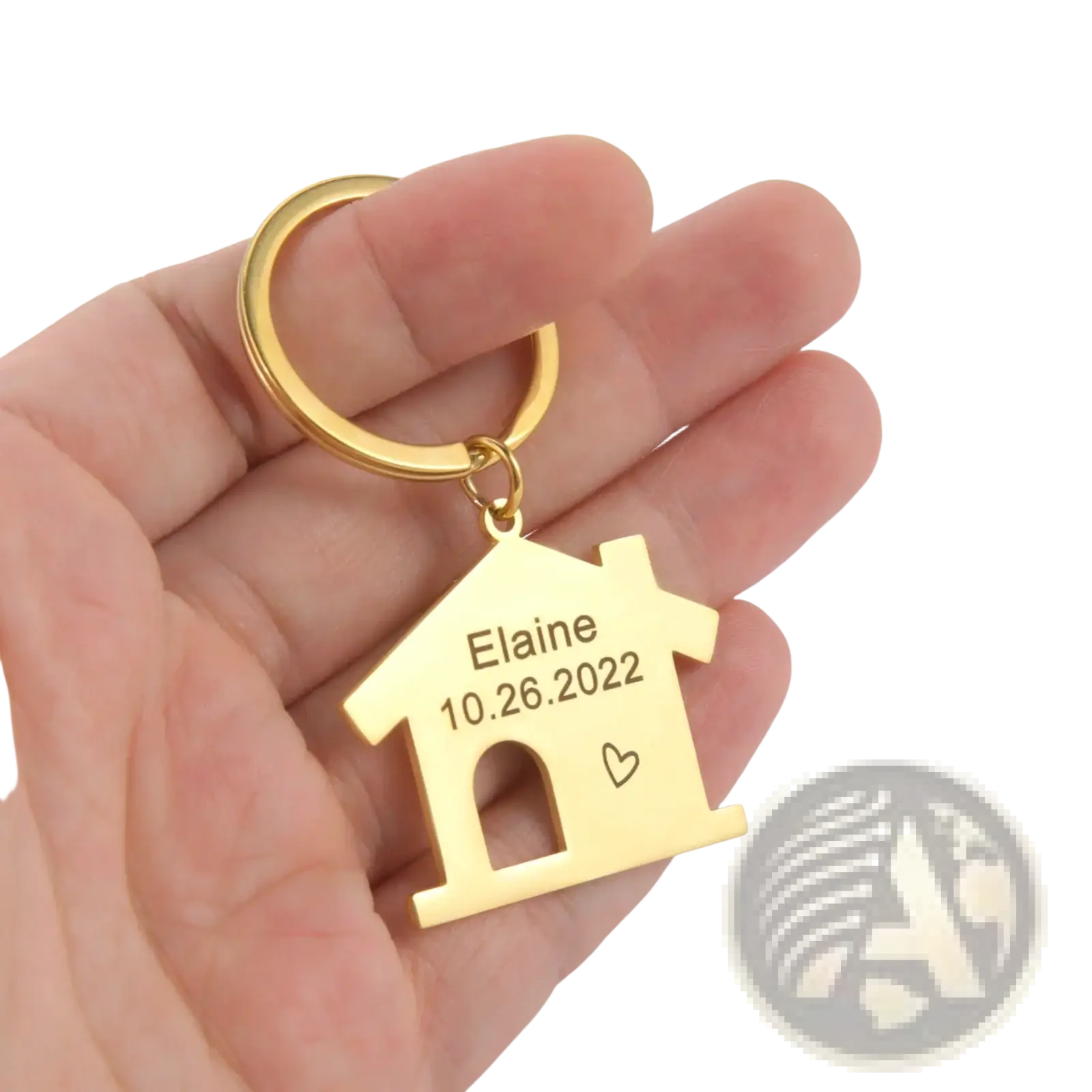 Gold-colored house-shaped keychain made of metal with engraved name and date personalized couple gift