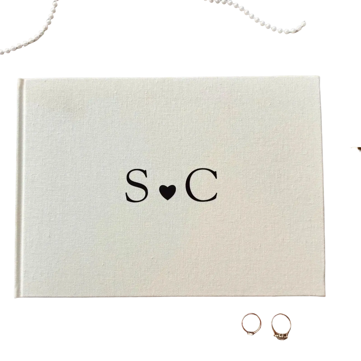 Beige linen textured personalized wedding guest book polaroid album with black monogrammed initials s heart c on cover